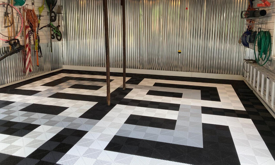 Black, gray and white Swisstrax garage floor square overlapping design Black, gray and white Swisstrax garage floor square overlapping design